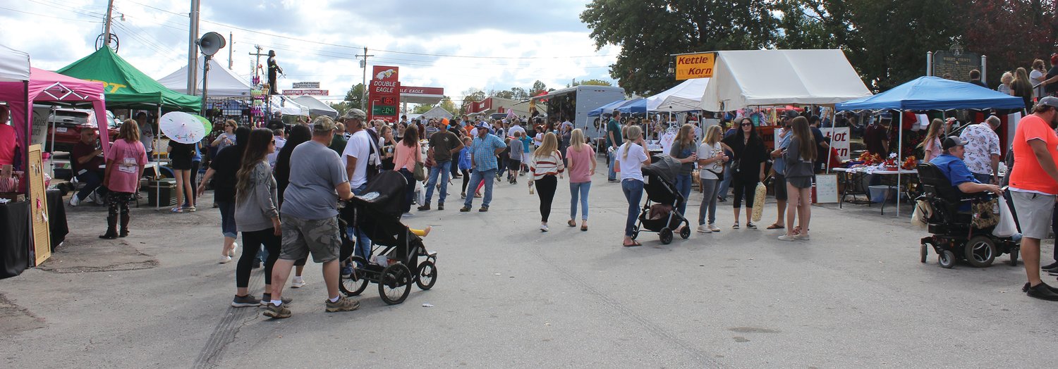A wide shot showing a large crowd attending the 42nd Annual Fall Festival in Hartville.